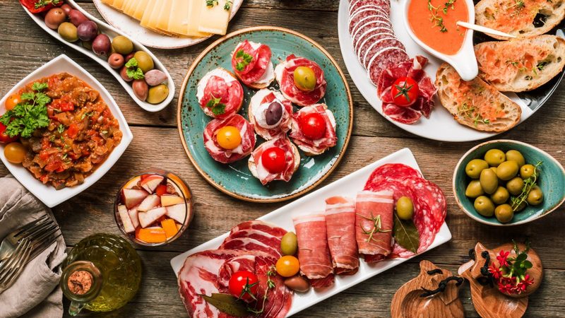 A table covered with tapas and small sharing plates.
