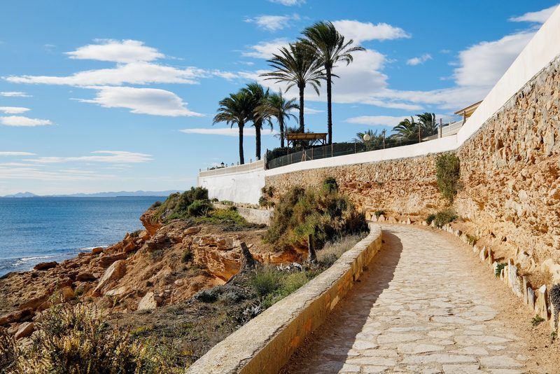 The coastal path of Cabo Roig running along the ochre cliffs, in Orihuela Costa