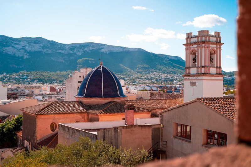 The rooftops of Dénia, its church dome and the Montgó massif